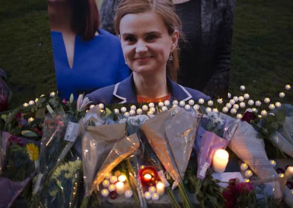 Flowers surround a picture of Jo Cox during a vigil in Parliament Square. Picture: Getty Images