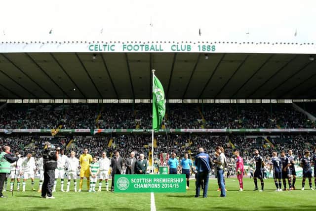 The Premiership champions flag unfurled prior to Celtic's league home opener against Ross County last season. Picture: SNS