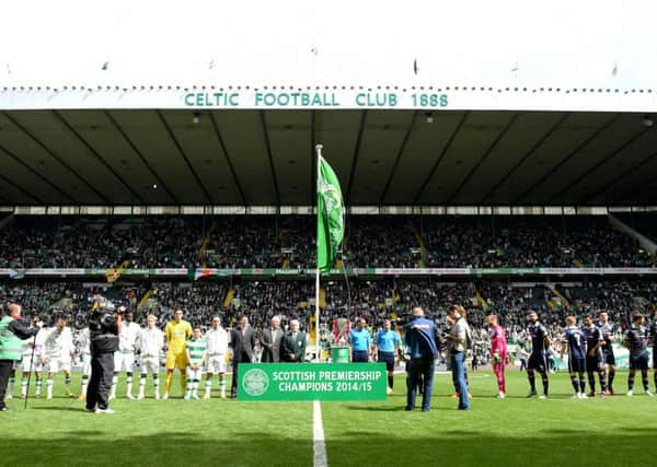 The Premiership champions flag unfurled prior to Celtic's league home opener against Ross County last season. Picture: SNS