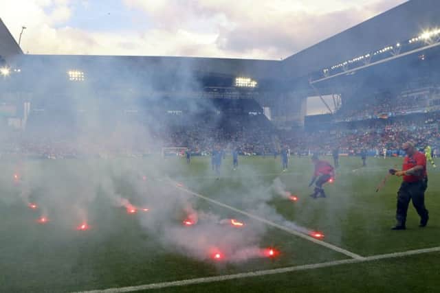 Flares are thrown on to the pitch during the Euro 2016 Group D match between the Czech Republic and Croatia at the Geoffroy Guichard stadium in Saint-Etienne. Picture: Darko Bandic/AP