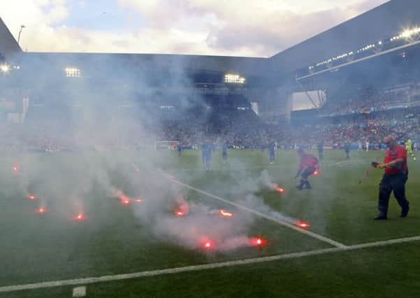 Flares are thrown on to the pitch during the Euro 2016 Group D match between the Czech Republic and Croatia at the Geoffroy Guichard stadium in Saint-Etienne. Picture: Darko Bandic/AP