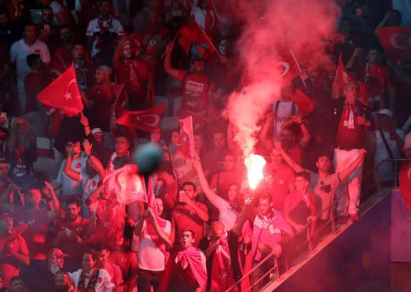 Turkey's fans light flares during the Euro 2016 Group D match against Spain. Picture: AP