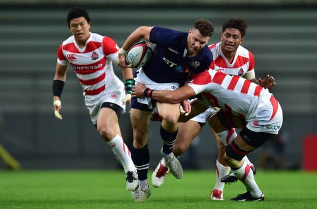 Duncan Taylor tries to get a Scottish attack going but is outnumbered by defenders.  Photograph: Getty Images