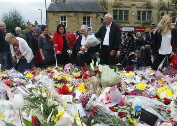 Gordon and Jean Leadbeater (centre), the parents of Labour MP Jo Cox, and her sister Kim Leadbeater (right) look at floral tributes left in Birstall yesterday. Picture: Danny Lawson/PA