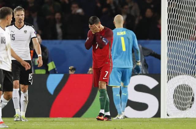 Cristiano Ronaldo holds his head in his hands after missing from the spot last night. Picture: Christophe Ena/AP