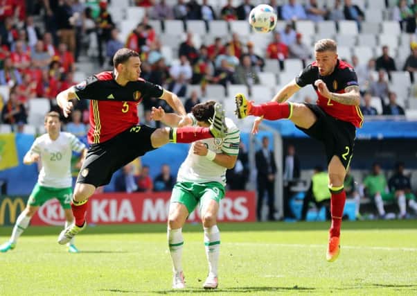 Shane Long appears to take a boot in the face as he and defenders Thomas Vermaelen and Toby Alderweireld challenge for the ball. Picture: PA