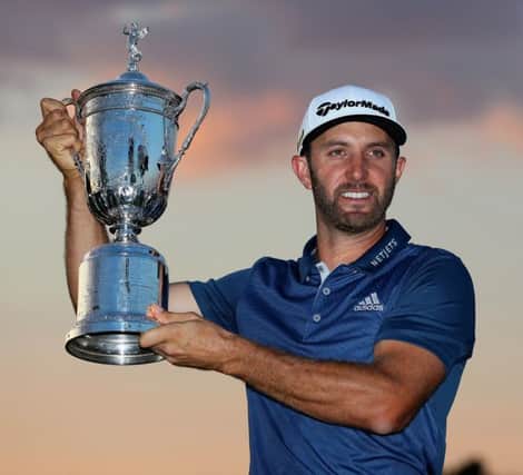 Dustin Johnson holds aloft the US Open trophy after his win at Oakmont. Picture: Getty Images