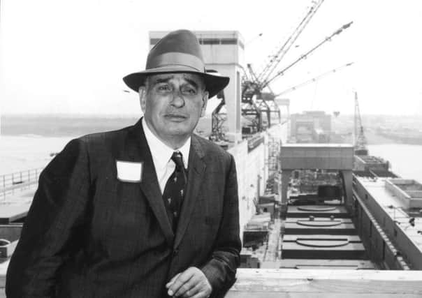 New York City parks commissioner Robert Moses, pictured in 1958, stands and leans on a wooden railing in front of a waterfront project site in New York City. Picture: Hulton Archive