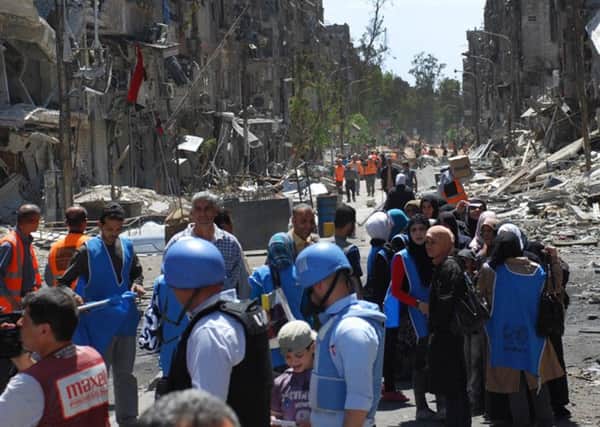 UN relief workers distribute aid on the southern edge of the Syrian capital Damascus. Picutre: AP