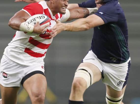 Japan's Amanaki Lelei Mafi, left, fends off Scotland's Richie Gray during the first Test at Toyota Stadium. Picture: Naoya Osato/Kyodo News via AP