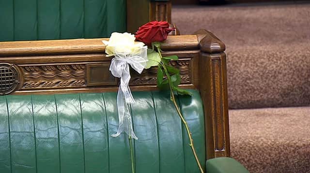 A white and red rose lie on Jo Cox's empty seat in the House of Commons. Picture: PA