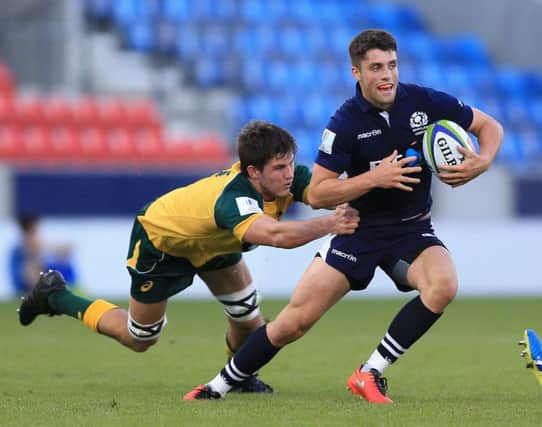 Scotland's Adam Hastings, right, makes a break against Australia during the Under-20 Rugby World Cup 5th place semi-final. Picture: Nigel French/PA Wire