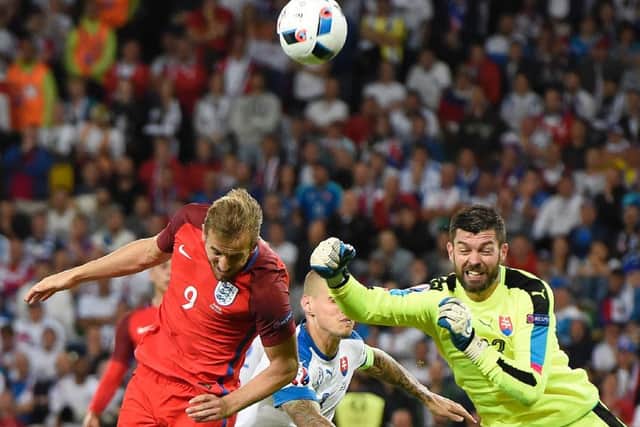 Slovakia goalkeeper Matus Kozacik punches the ball clear ahead of England forward Harry Kane.Picture: Joe Klamar/AFP/Getty
