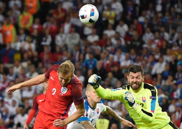 Slovakia goalkeeper Matus Kozacik punches the ball clear ahead of England forward Harry Kane.Picture: Joe Klamar/AFP/Getty