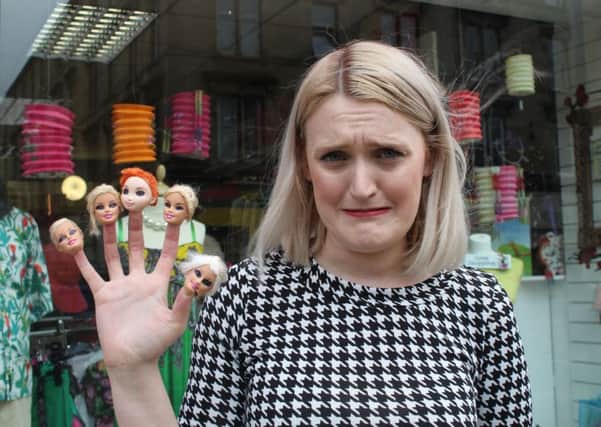 Charlene Ritchie, shop manager in Kelvinbridge, Glasgow, shows off some of the gruesome severed doll heads donated to the charity. Picture: Shelter/PA Wire