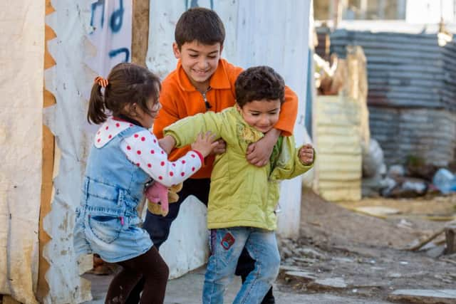 Syrian refugee children fight over a teddy bear at Rajab, an Informal Tented Settlement in Lebanons Bekaa Valley that houses Syrian refugees.