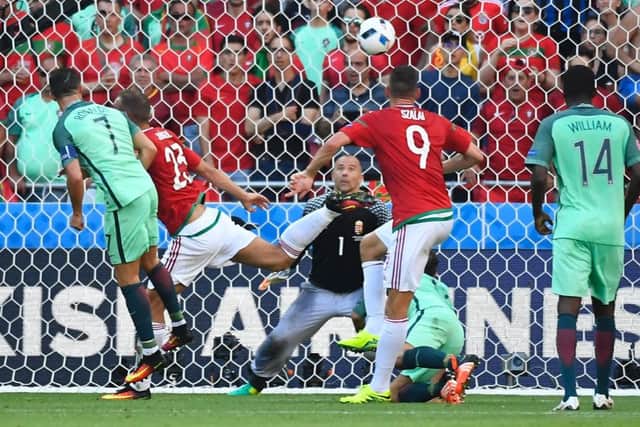 Portugal forward Cristiano Ronaldo, left, heads home the second of his two goals in the 3-3 draw with Hungary. Picture: Joe Klamar/AFP/Getty