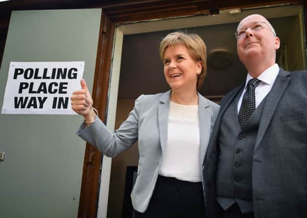 SNP Leader Nicola Sturgeon casts her vote in the EU referendum with her husband Peter Murrel . Picture: Getty