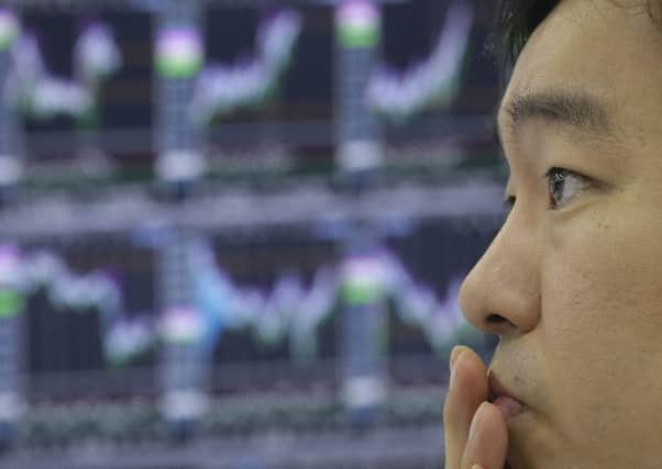 A currency trader checks monitors at the foreign exchange room of KEB Hana Bank in Seoul, South Korea. Picture: Ahn Young-joon/AP