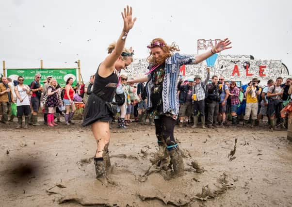 Joanna Redman, 23, and Beth Goodenough, 24, get stuck into this years mud bath. Photograph: Adam Gray/SWNS