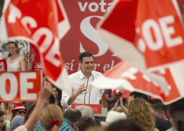 Party supporters wave flags as Spanish Socialist leader Pedro Sanchez takes to the stage during an election rally on the last day of campaigning, in Madrid. Picture: AP