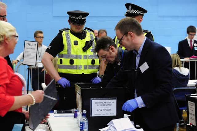 Police scrutinise the opening of a ballot box Picture: Michael Gillen