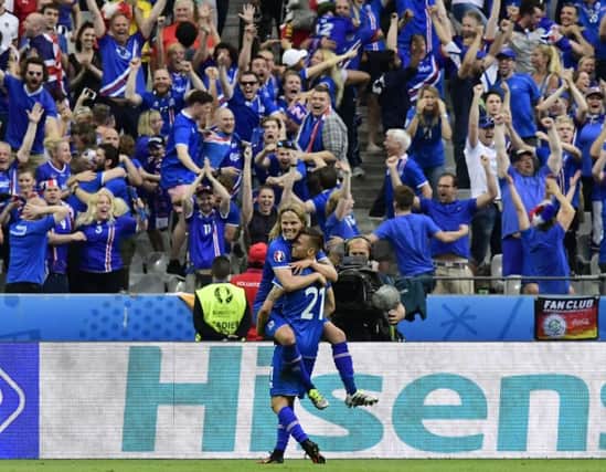 Icelands midfielder Arnor Ingvi Traustason celebrates his famous winning goal against Austria with team-mate Birkir Bjarnason. 
Picture: AFP/Getty Images