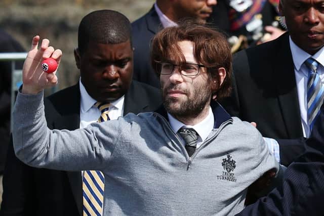 Comedian Simon Brodkin, also known as Lee Nelson, disrupts the press conference. Picture: PA