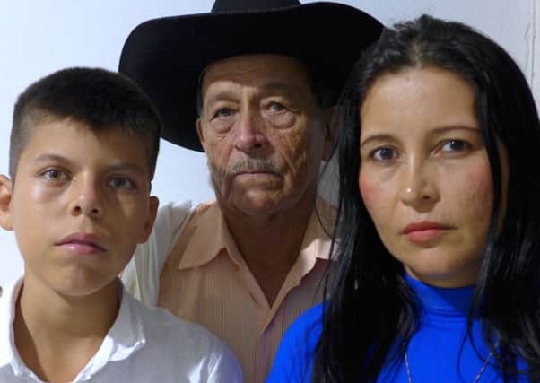 The pain and the tears wont stop. I would give anything just to know what happened,' says Hector Abril, father of murdered environmental activist Daniel Abril, pictured with his grandson Daniel junior and daughter. Photograph: Michael Gillard