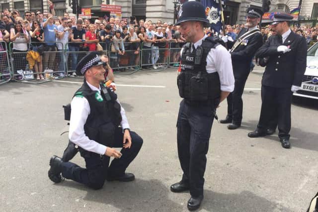 The touching moment the met police officer got down on one knee to propose. Picture: Met LGBT Network