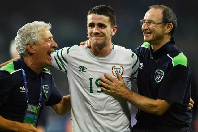 Robbie Brady, centre, is congratulated by head coach Martin ONeill, right, after the 1-0 victory over Italy at Euro 2016. Picture: Mike Hewitt/Getty
