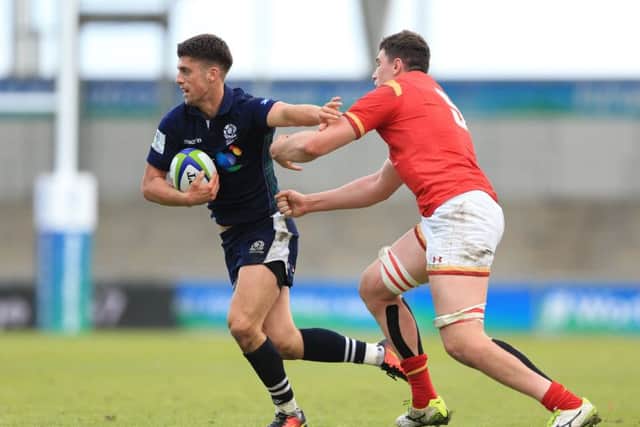 Scotland's Adam Hastings is tackled by Seb Davies during the Under 20's clash in Manchester. Picture: PA