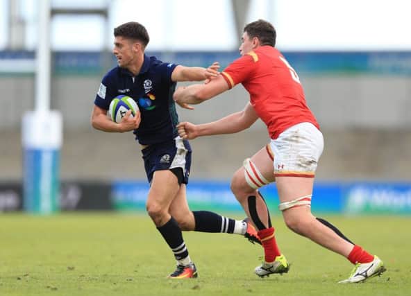 Scotland's Adam Hastings is tackled by Seb Davies during the Under 20's clash in Manchester. Picture: PA