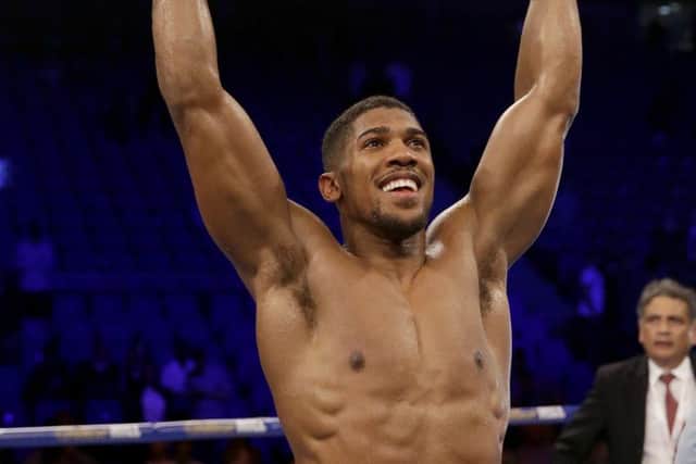 Anthony Joshua holds aloft his IBF world heavyweight belt after defeating Dominic Breazeale. Picture: AP