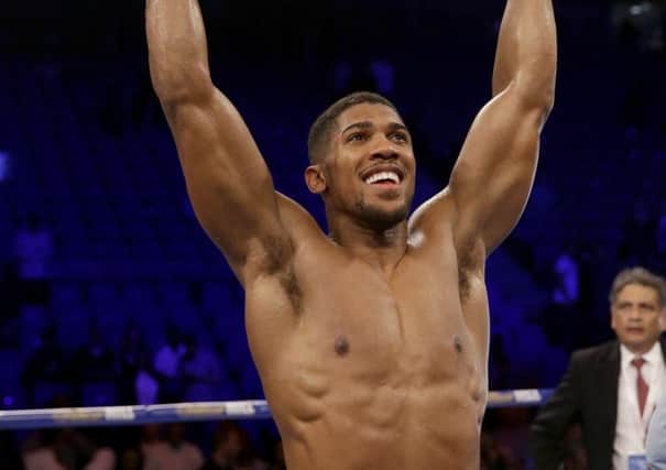 Anthony Joshua holds aloft his IBF world heavyweight belt after defeating Dominic Breazeale. Picture: AP