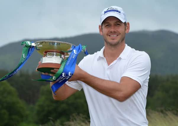 James Heath holds the trophy after winning the SSE Scottish Hydro Challenge with a record-breaking 21-under-par aggregate. Picture: Getty