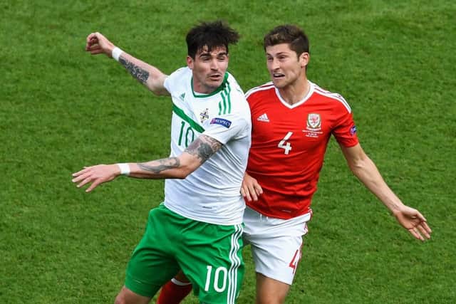 Striker Kyle Lafferty, left, challenges Ben Davies of Wales during  the last-16 clash at Euro 2016. Picture: Getty