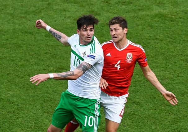 Striker Kyle Lafferty, left, challenges Ben Davies of Wales during  the last-16 clash at Euro 2016. Picture: Getty