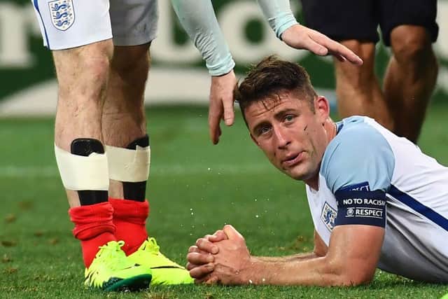 England's defender Gary Cahill is comforted by a teammate after full time. Picture: AFP/Getty
