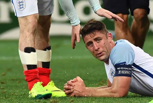 England's defender Gary Cahill is comforted by a teammate after full time. Picture: AFP/Getty