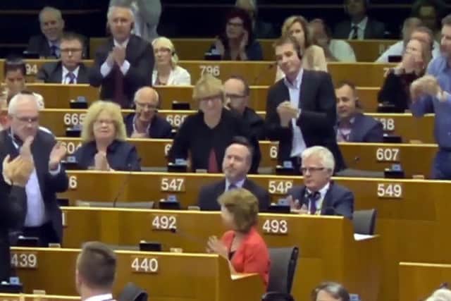 Mr Smith receives a standing ovation from his group colleagues in Brussels. Picture: Contributed