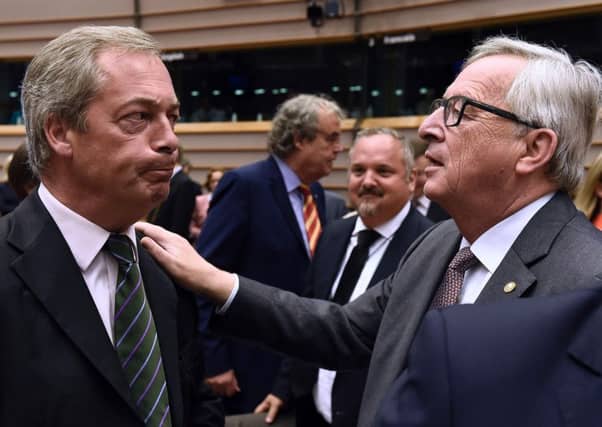 Ukip leader Nigel Farage looks unhappy as he meets EU Commission President Jean-Claude Juncker at the parliament. Picture: AFP/Getty Images