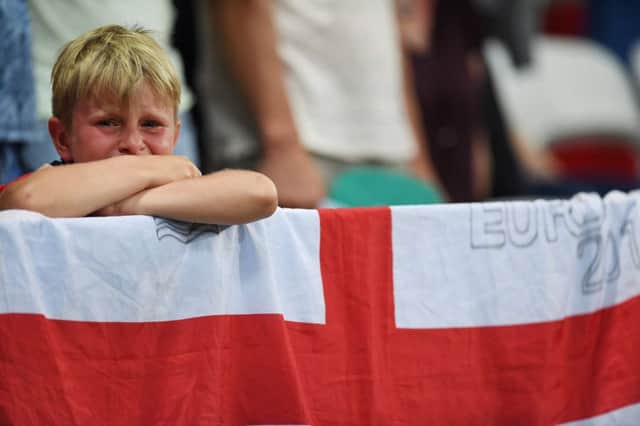 A young England fan looks on distraught after England's loss to Iceland at Euro 2016. Picture: AFP/Getty