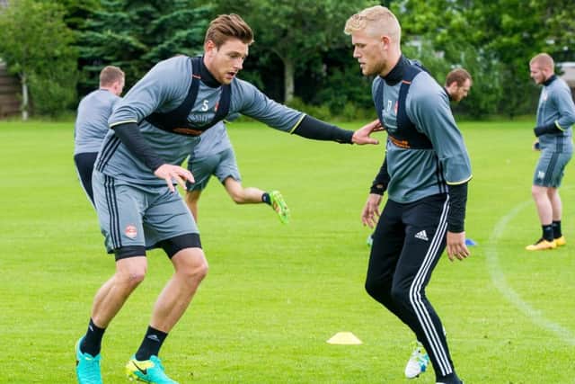 Ash Taylor, left, and new signing Jayden Stockley train ahead of Aberdeens clash with Fola Esch. Picture: SNS
