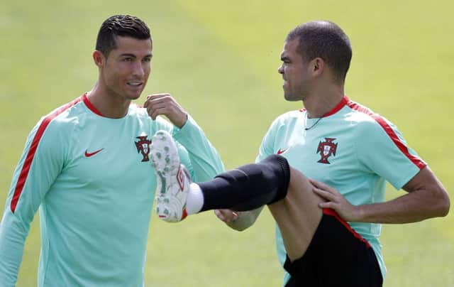 Portugal pair Cristiano Ronaldo, left, and Pepe in training ahead of tonight's quarter-final against Poland. Picture: AP/Michael Sohn