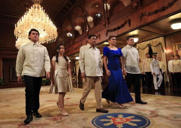 Rodrigo Duterte walking with his children after the oath-taking. Picture: AFP/Getty Images