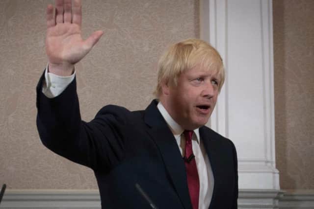 Boris Johnson waves during a press conference at St Ermin's Hotel in London. Picture: PA