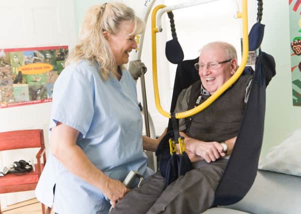 Moni Robson working with motor neurone disease sufferer Jim Grant at Leuchie House. Picture: DN Anderson