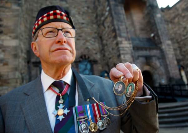 Major General Mark Strudwick with a locket containing pictures of his grandparents Francis & Irene Beresford. Picture: Scott Louden