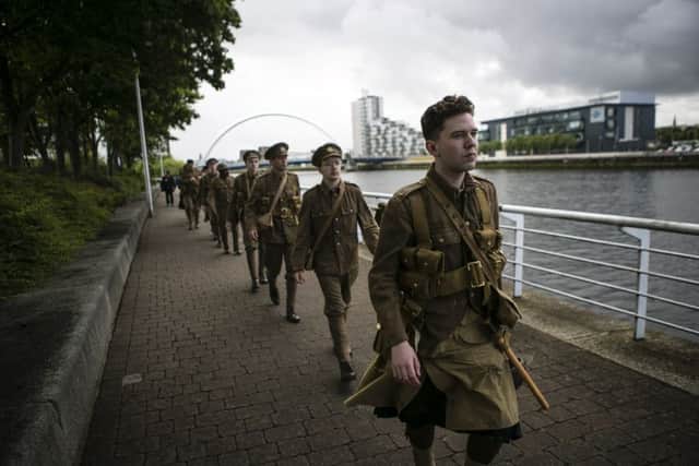 The performers march alongside the Clyde. Picture: Eoin Carey